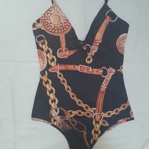 Gold and black one piece body suit